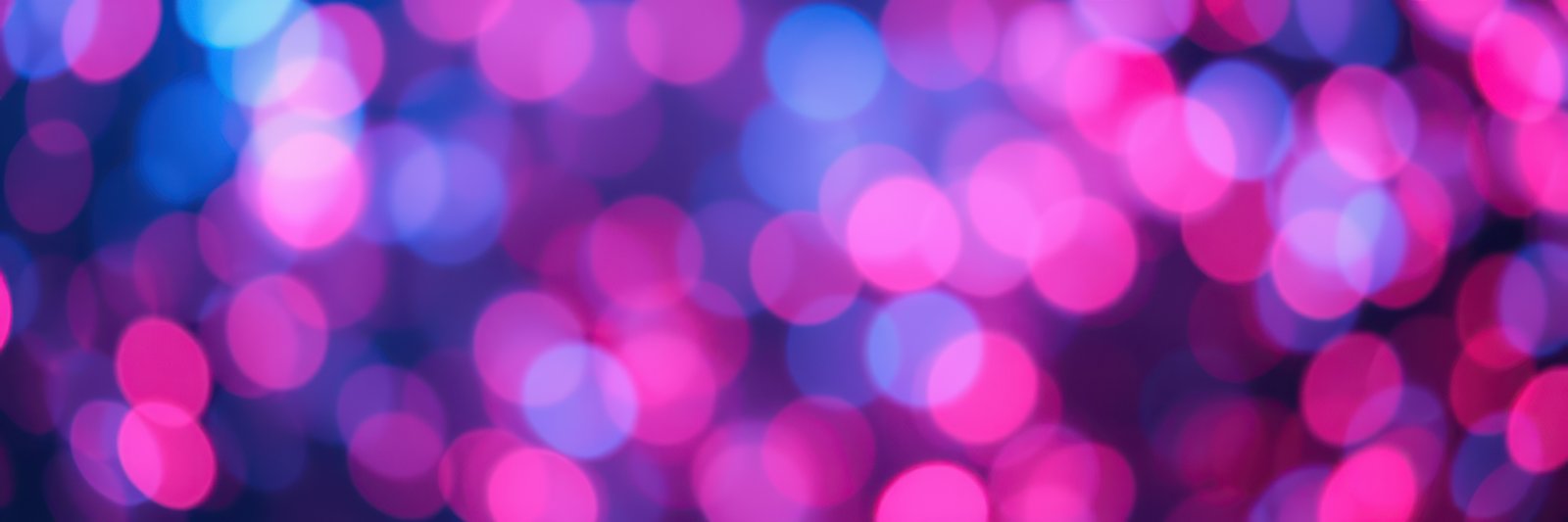 Bright bokeh lights create a colorful atmosphere at a nighttime celebration
